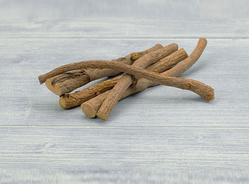 Licorice roots on grey wood background. Also called Yashtimadhu. Anti-oxidant, Anti-inflammatory, blocks DHT that causes baldness in men. Natural ingredient in Vedic Tiger's Hair Growth Starter Kit. 