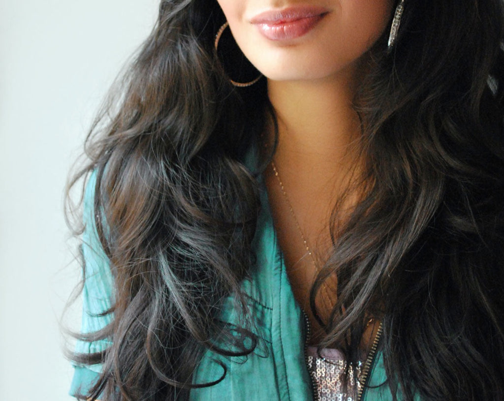 Close up of woman with beautiful long dark healthy shiny hair with Vedic Tiger's natural hair care products